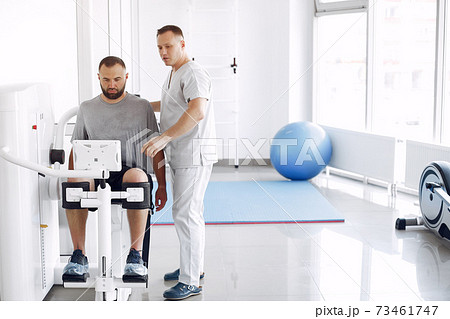 Doctor with a patient in physiotherapy clinic Doctor with a patient in physiotherapy clinic 73461747