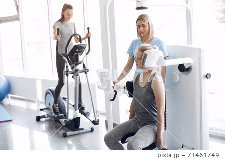 Woman having rehabilitation after injury in physiotherapy room Woman having rehabilitation after injury in physiotherapy room 73461749