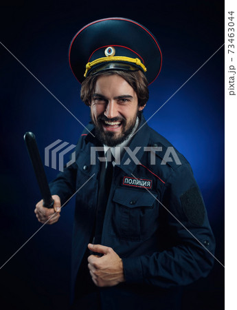 a man in a Russian police uniform with a baton. English translation of " Police" a man in a Russian police uniform with a baton. English translation of " Police" 73463044