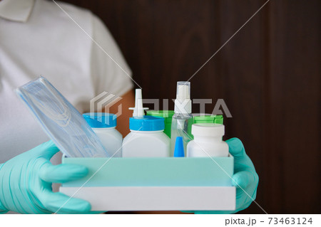 Medicine woman courier in mask and gloves with medical pills purchases Medicine woman courier in mask and gloves with medical pills purchases 73463124