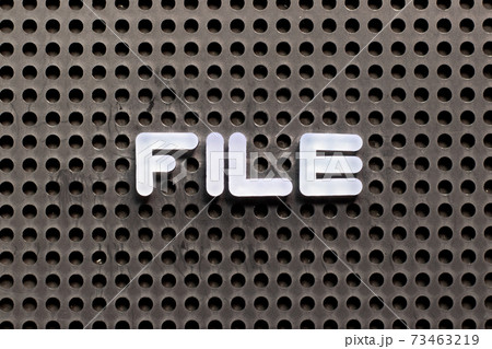 White color letter in word file on black pegboard background 73463219