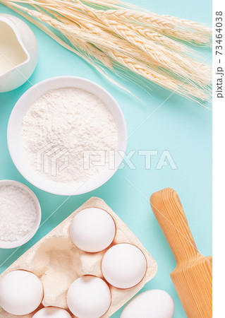 Ingredients for baking on light blue background. 73464038