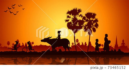 country life of Asia children play banana horse ride buffalo while monk receive food on sunrise time country life of Asia children play banana horse ride buffalo while monk receive food on sunrise time 73465152