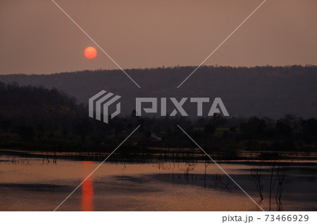 The sun is rising in the morning over the mountains in Thailand. The sun is rising in the morning over the mountains in Thailand. 73466929