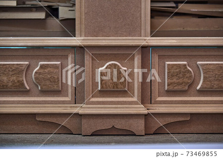 Joinery. Mdf cabinet carcass with moldings and decor. Wooden furniture manufacturing process 73469855