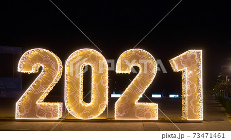 blurred background. defocused numbers 2021 on dark background blurred background. defocused numbers 2021 on dark background 73471461