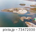 Scenic aerial drone birds eye view of swallow sand river or lake shore due to drought and water pond reservoir dam draining. Natural disaster of arid, warmand dry climate change 73472030