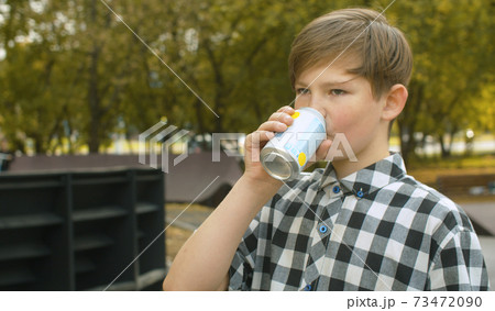 Boy drinking soda water Boy drinking soda water 73472090