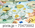 Various cryptocurrency coins on paper dollar and euro banknotes. Bitcoin, ethereum, litecoin and others modern virtual currency 73473002