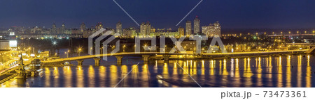 Kyiv (Kiev) city, the capital of Ukraine at night beside the Dnipro (Dniepr) river with reflection in water Kyiv (Kiev) city, the capital of Ukraine at night beside the Dnipro (Dniepr) river with reflection in water 73473361