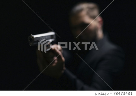 Blur background of gangster holding gun Blur background of gangster holding gun 73473431
