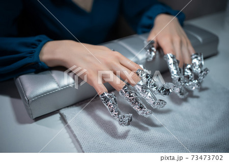 closeup shot and manicure artist making nail cleaning and polishing closeup shot and manicure artist making nail cleaning and polishing 73473702