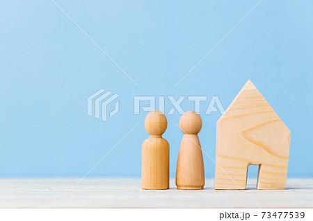 Little wooden men and house miniature close up 73477539