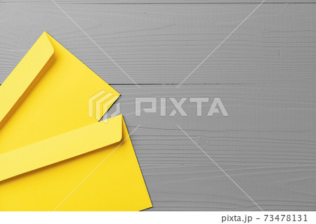 Yellow envelope on gray background top view Yellow envelope on gray background top view 73478131