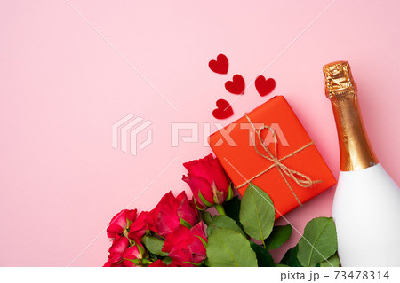 Roses bouquet, bottle of champagne and gift box flat lay 73478314