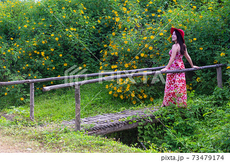 Beautiful woman in nature flower. 73479174