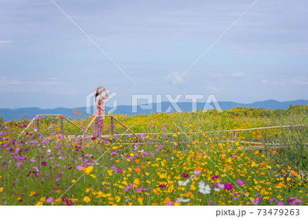 Beautiful woman in nature flower. 73479263