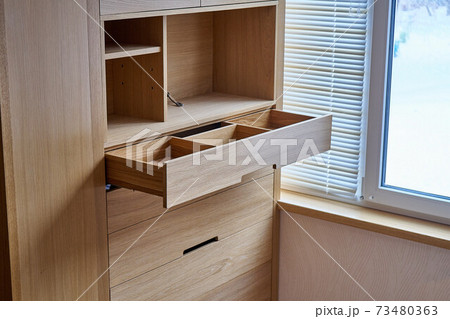 Wooden cupboard with opened drawer. Modern furniture Wooden cupboard with opened drawer. Modern furniture 73480363