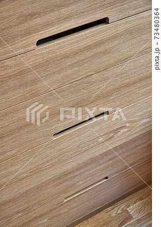 Wooden cupboard with drawers in daylight. Modern furniture Wooden cupboard with drawers in daylight. Modern furniture 73480364