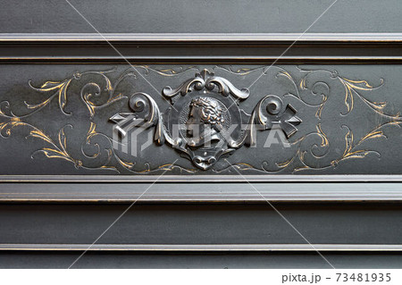 Old-fashioned antique ornamental piano with carved pillars. After restoration 73481935