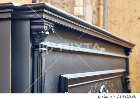 Old-fashioned antique ornamental piano with carved pillars. After restoration 73481936