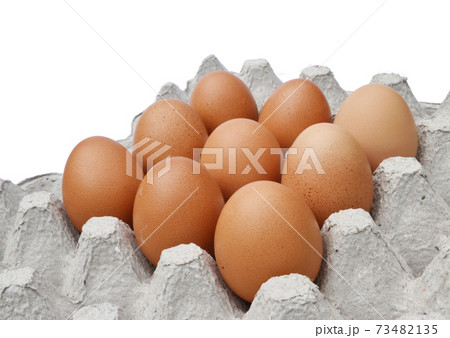 Nine hen eggs in egg tray on white background , Highly nutritious food from poultry 73482135