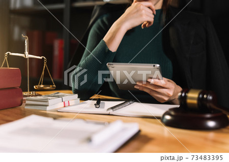 justice and law concept.Male judge in a courtroom  the gavel, working with smart phone and laptop and digital tablet 73483395