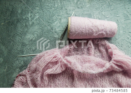 Knitting background flatlay.Kknitted pullover on a concrete background. 73484585