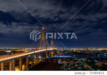 Large suspension bridge over Chao Phraya river with traffic at night Large suspension bridge over Chao Phraya river with traffic at night 73484923