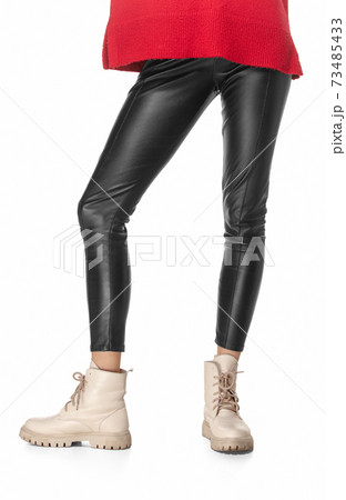 Slim legs of young girl in black leggings and boots isolated on white background Slim legs of young girl in black leggings and boots isolated on white background 73485433