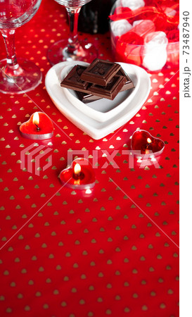 Valentines day. Glasses, red roses, candles - red background Valentines day. Glasses, red roses, candles - red background 73487940