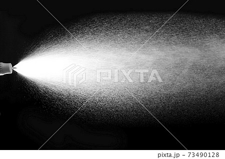 Spraying mist of air gun or atomizer for cosmetic concept isolated on black background. 73490128