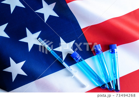Vial syringe. Medical syringe with needle for protection flu virus and coronavirus. Covid vaccine usa flag of america. Medicine concept vaccination hypodermic injection treatment. 73494268