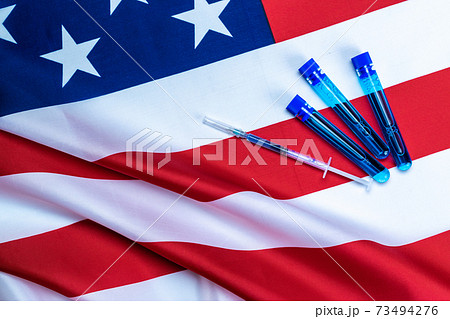Vaccine bottle. Medical syringe with needle for protection flu virus and coronavirus. Covid inoculation usa flag of america. Medicine plastic vaccination equipment with needle. 73494276