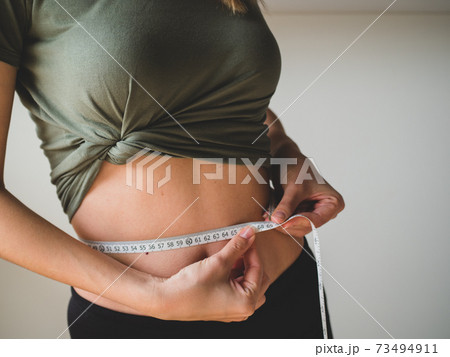 Fitness Body with a Measurement Tape. Beautiful Athletic Slim Woman  Measuring Her Waist by Measure Tape Stock Photo - Image of slim, people:  81705162