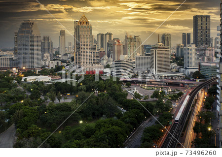 Bangkok business district with the public park area anf the sky train in the foreground at sunset time. Bangkok business district with the public park area anf the sky train in the foreground at sunset time. 73496260