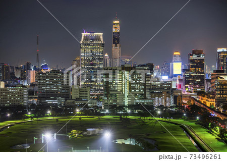 Bangkok business district with the public park area anf the sky train in the foreground at sunset time. 73496261