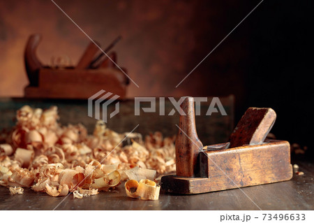 Old wooden jointers and shaving on wooden table. 73496633
