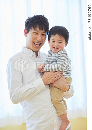赤ちゃんと写真撮影をするお父さん 子供 家族 記念 赤ちゃんと写真撮影をするお父さん 子供 家族 記念 73496760