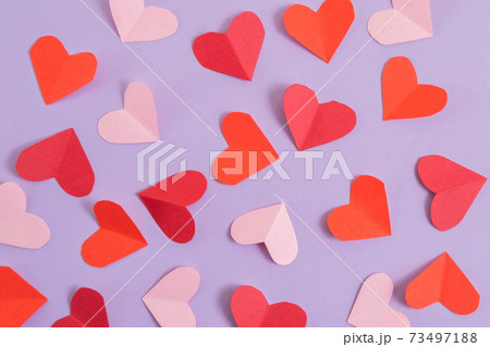 Valentine's Day background. Pink and red hearts on a pastel purple background. Valentine's Day concept. Layout for postcards and congratulations. Flat lay, top view, copy space 73497188