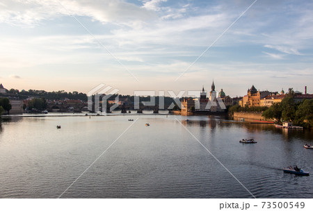 Charles bridge prague sunset light beautiful river water panoramic view 73500549
