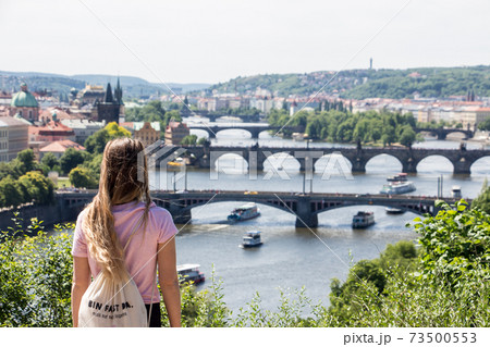 Person in front of Prague panorama charles bridge river from mountain skyview 73500553