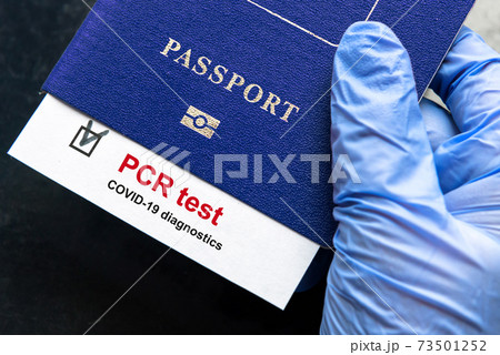 Coronavirus and travel concept, mark of COVID-19 PCR testing in tourist passport 73501252
