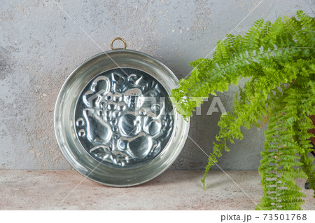 Antique copper mold on a concrete background. 73501768