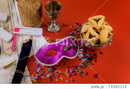 Hamans ears cookies for Purim Jewish holiday celebration noisemaker and mask carnival kosher wine 73502114