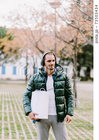 man holding White paper bag and white t-shirt mockup man holding White paper bag and white t-shirt mockup 73503434