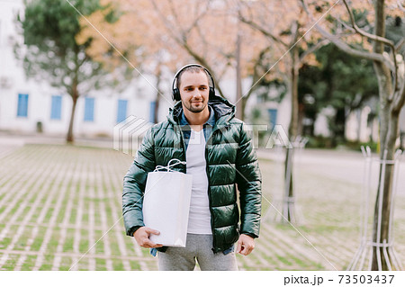 man holding White paper bag and white t-shirt mockup man holding White paper bag and white t-shirt mockup 73503437