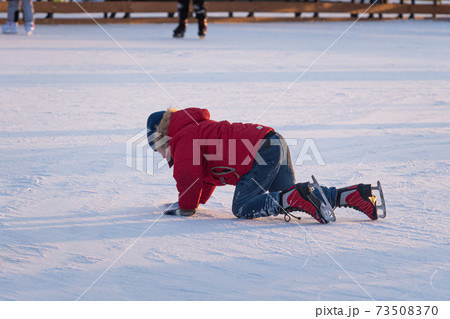 Boy fell down while skating at ice rink. Sport trauma. Boy fell down while skating at ice rink. Sport trauma. 73508370