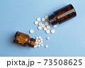 Various medicine. White round pills and two pill bottle 73508625