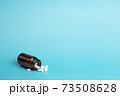 Various medicine. White round pills and pill bottle 73508628